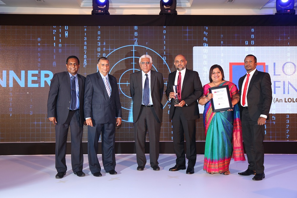 (Standing from Left to Right) Mr. Channa de Silva, General Manager/CEO, Lanka Clear (Pvt) Ltd, Mr. Anil Amarasuriya, Chairman Lanka Clear (Pvt) Ltd, Dr. Indrajit Coomaraswamy, Governor of the Central Bank of Sri Lanka, Mr. Ashan Nissanka, Director/CEO of LOLC Finance, Mrs. Roshani Weerasekera, Head of Liability Management, LOLC Finance and Mr. Chinthaka Jayasinghe, Head of Business Solutions, Banking – LOLC Technologies.   