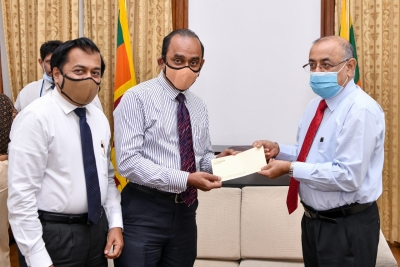 Chairman of People’s Bank - Sujeewa Rajapaksa handing over a cheque for Rs. 10 million for the COVID-19 Healthcare and Social Security Fund to the President’s Secretary -        Dr. P. B. Jayasundera. Acting Chief Executive Officer/ General Manager - Boniface Silva is also present in the picture