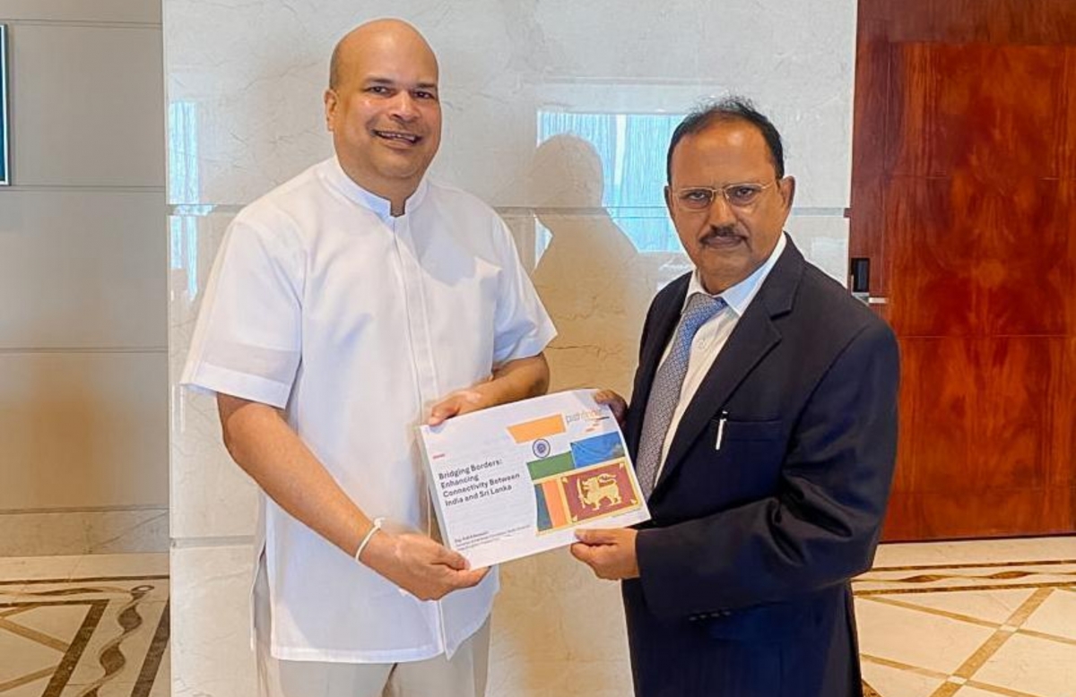 Milinda Moragoda presenting a copy of the Pathfinder Foundation’s Study Group Report on India-Sri Lanka Physical Connectivity to Indian National Security Advisor Ajit Kumar Doval